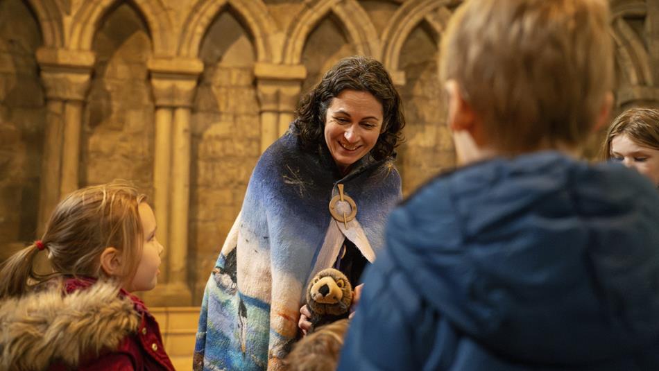Elizabeth Baker, local storyteller and writer, entertaining children at Durham Cathedral with thought-provoking tales.