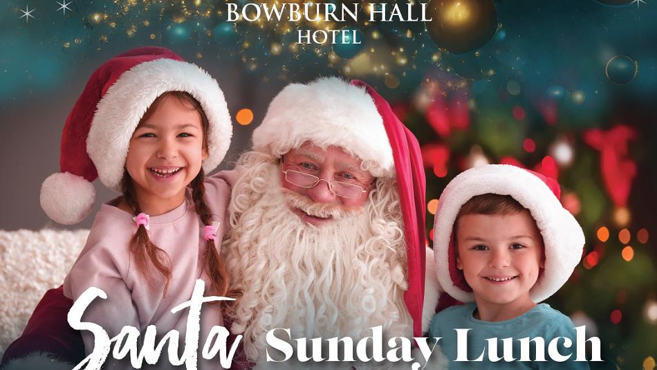 Santa and two children wearing Santa hats at Bowburn Hall Hotel.