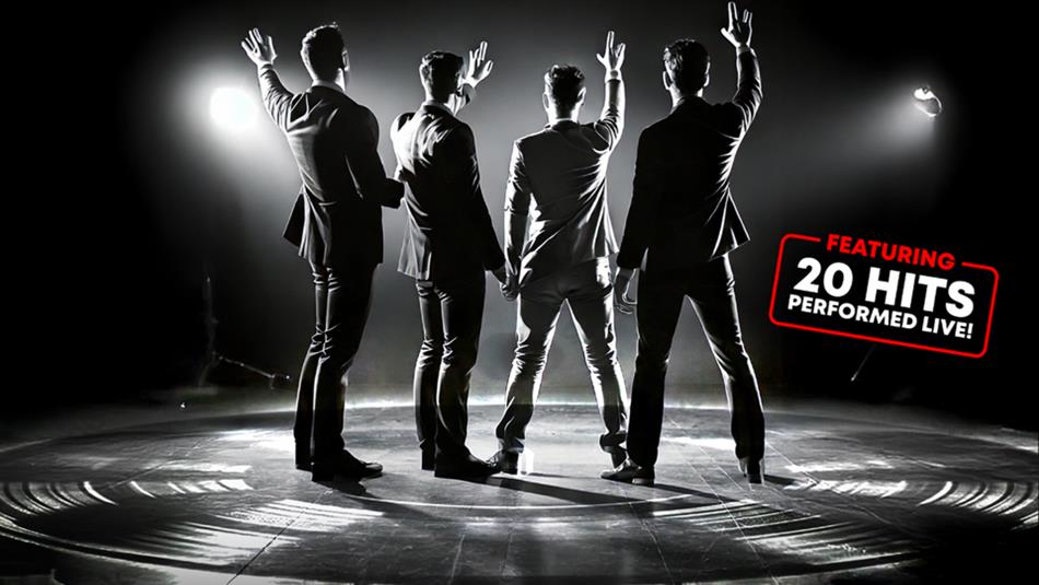 Black and white photo of a 'Frankie Valli and the Four Seasons' tribute band on stage, waving at the crowd.