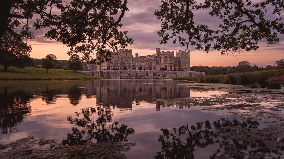 Twilight photo of Raby Castle and its lake.