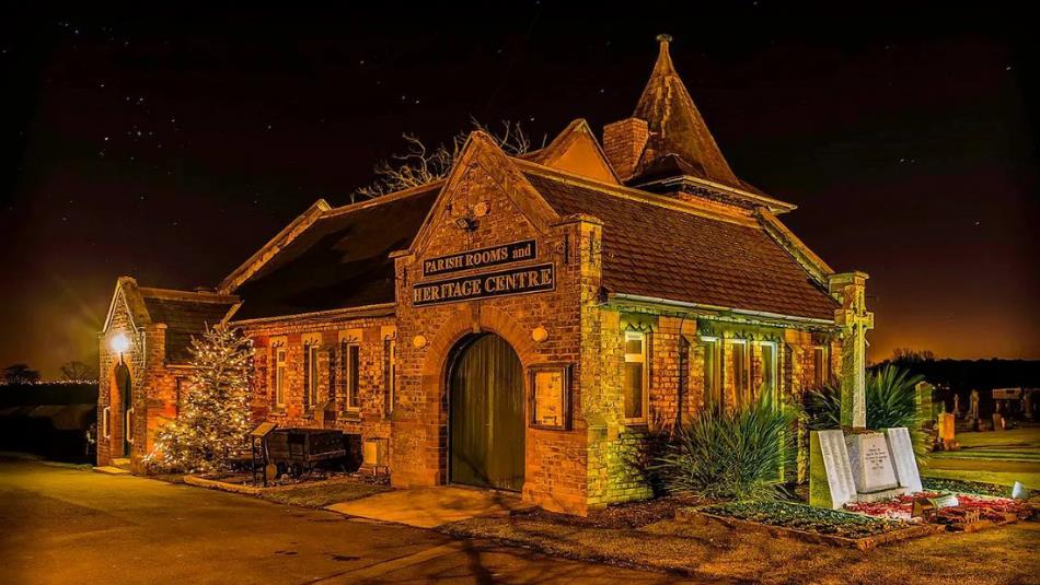 A historic parish hall lit by low lighting in the dark