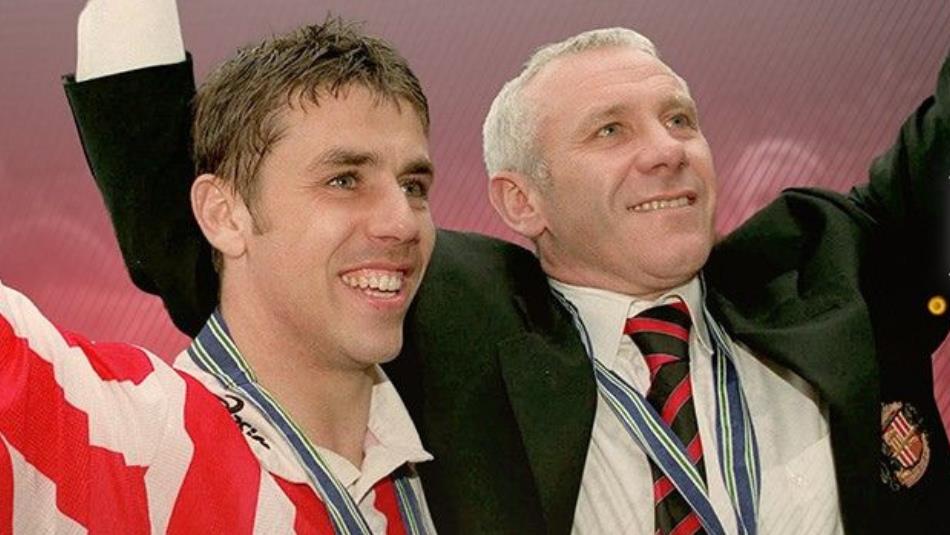 Old photo of Peter Reid and Kevin Phillips looking off to the right and celebrating with their arms up