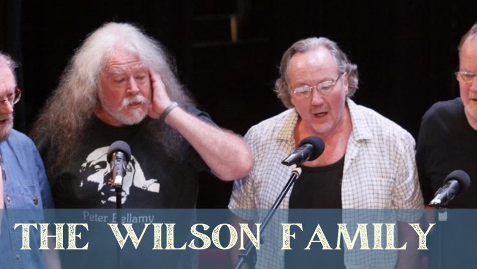 Four men singing on stage, with text underneath The Wilson Family.