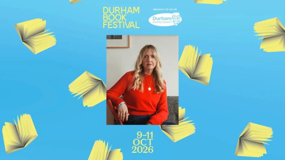 A person in a red jumper sat on a chair, on a light blue background surrounded by books.
