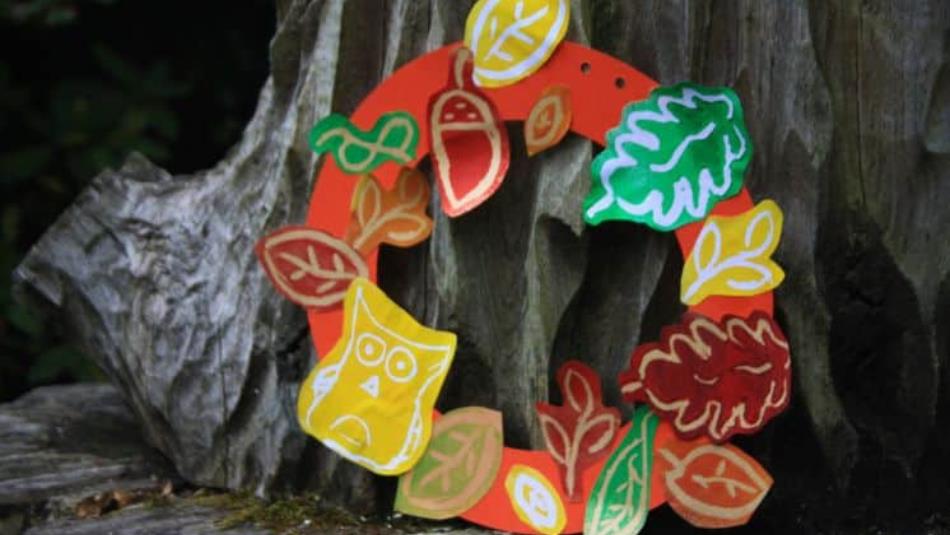 A handmade paper autumn wreath on a tree.