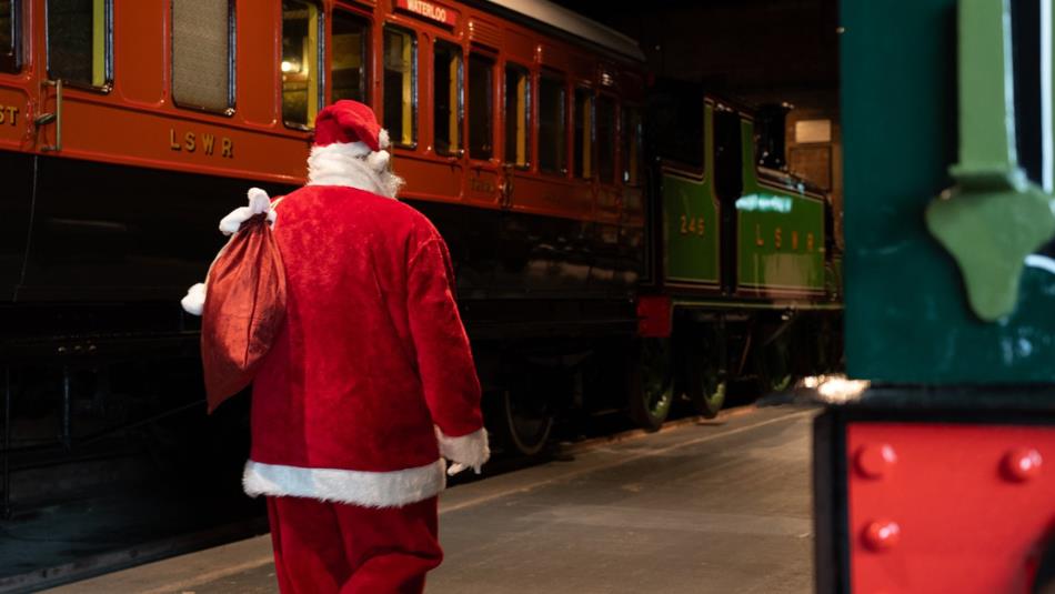 Santa walking through train carriages.