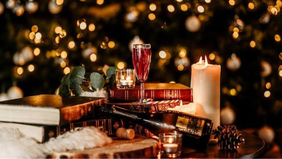 A Christmas table of books and candle