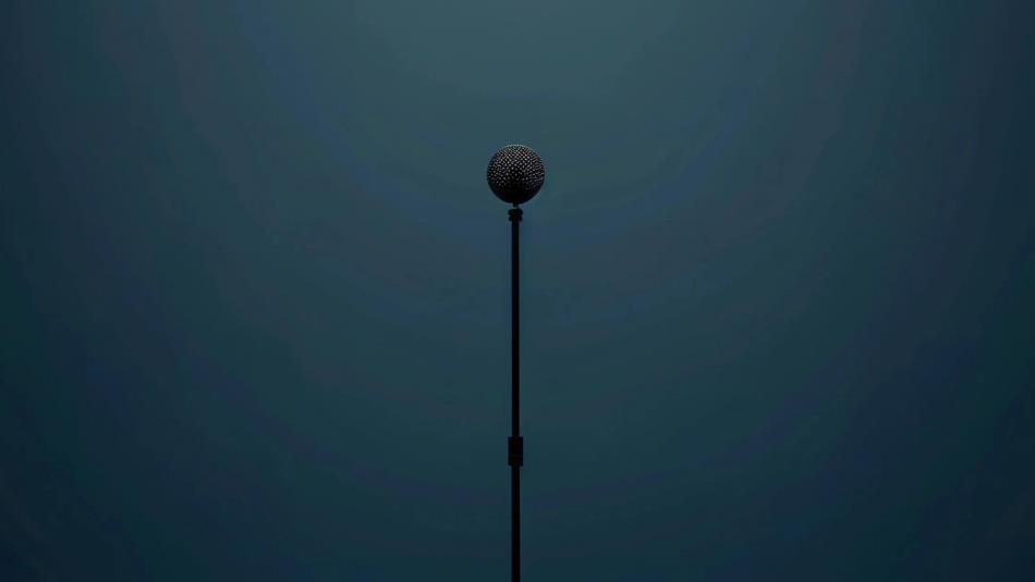 A black microphone and stand on a navy background