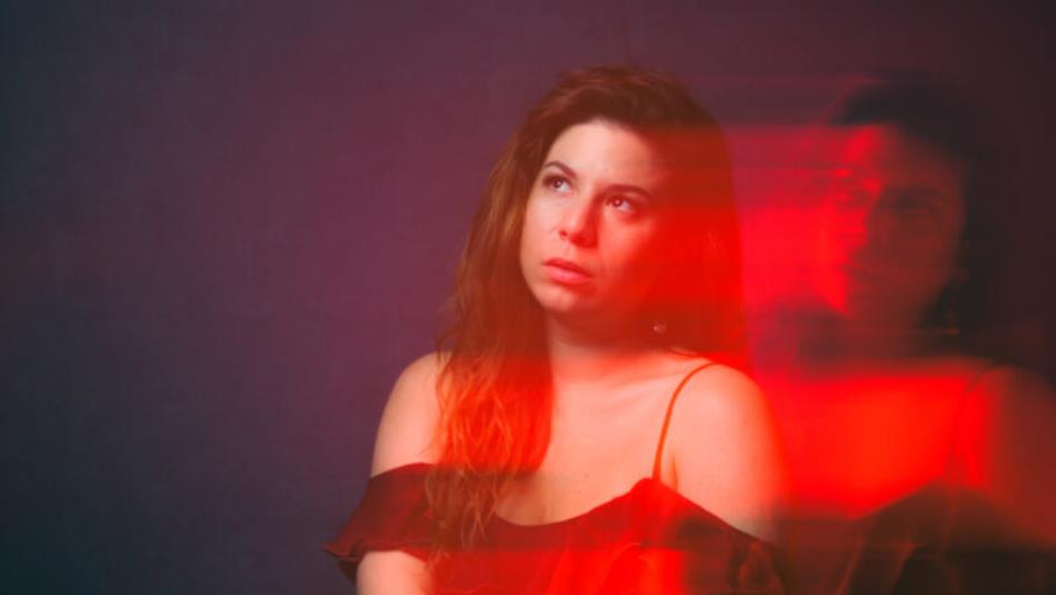 Person looking off to the left with a blurred red affect
