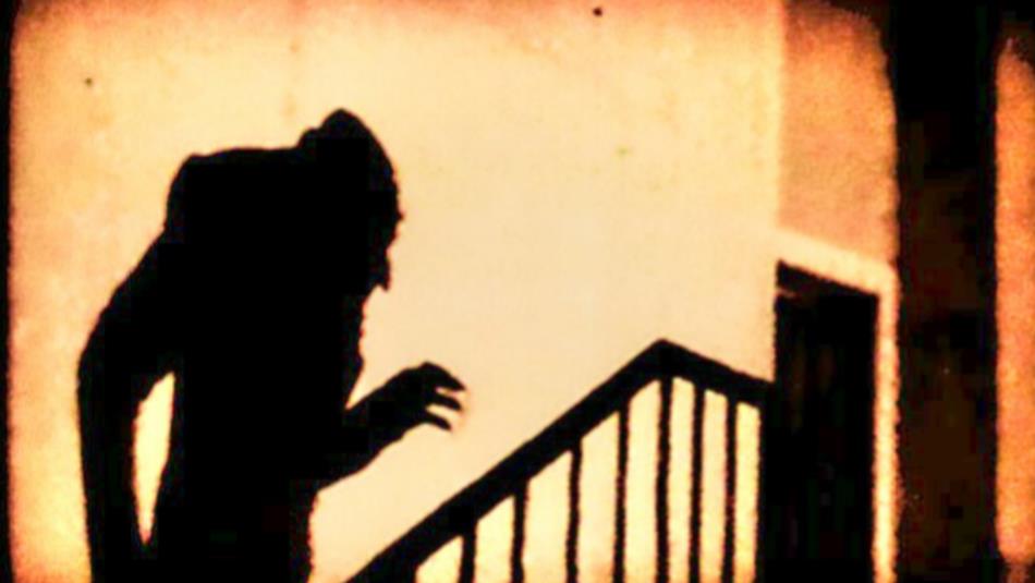 The silhouette of the vampire Nosferatu climbing up the stairs.