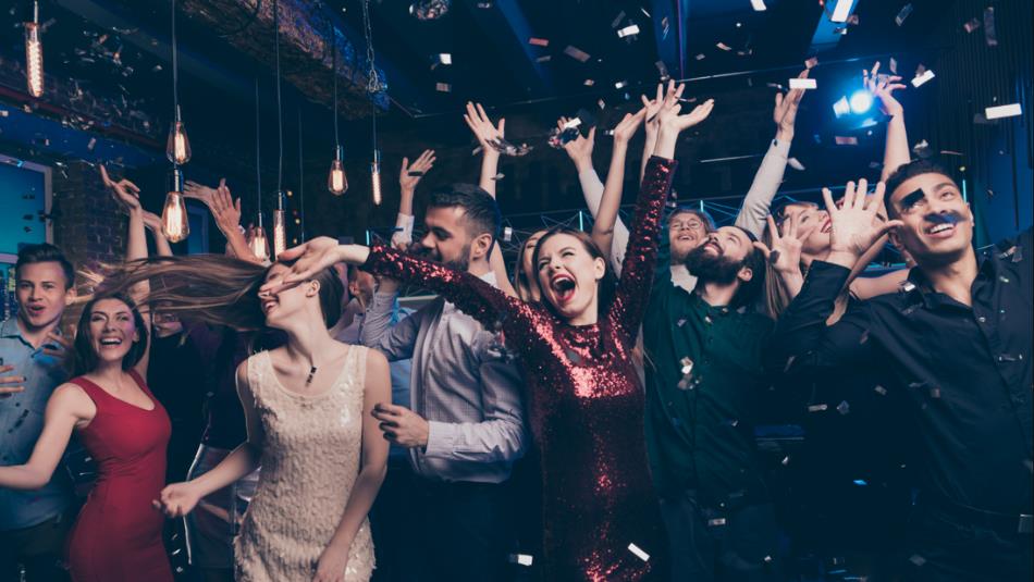 People dancing with their arms in the air.