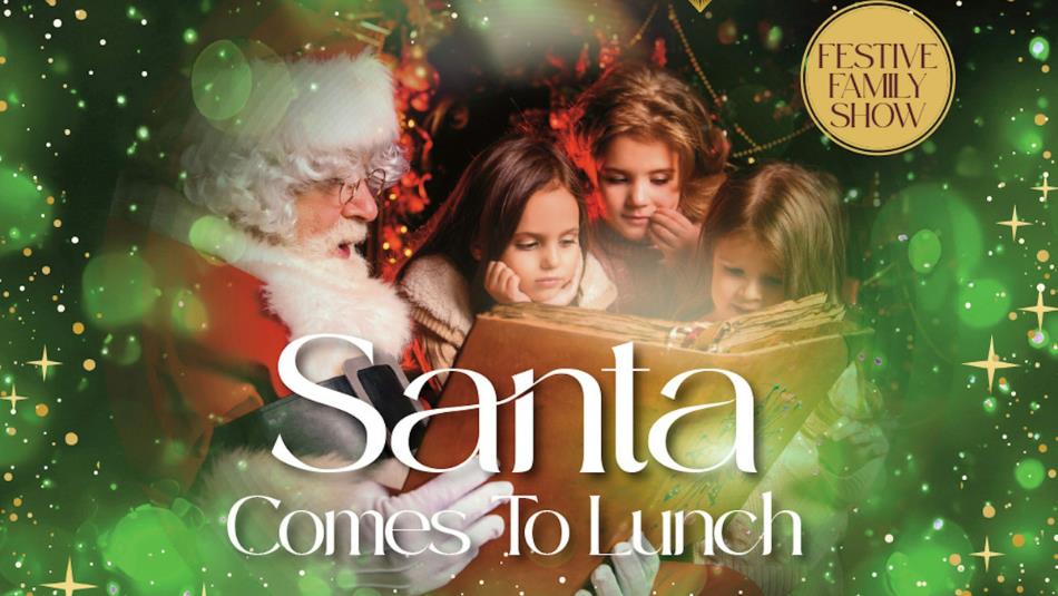 Santa Claus is reading a story to a group of children.