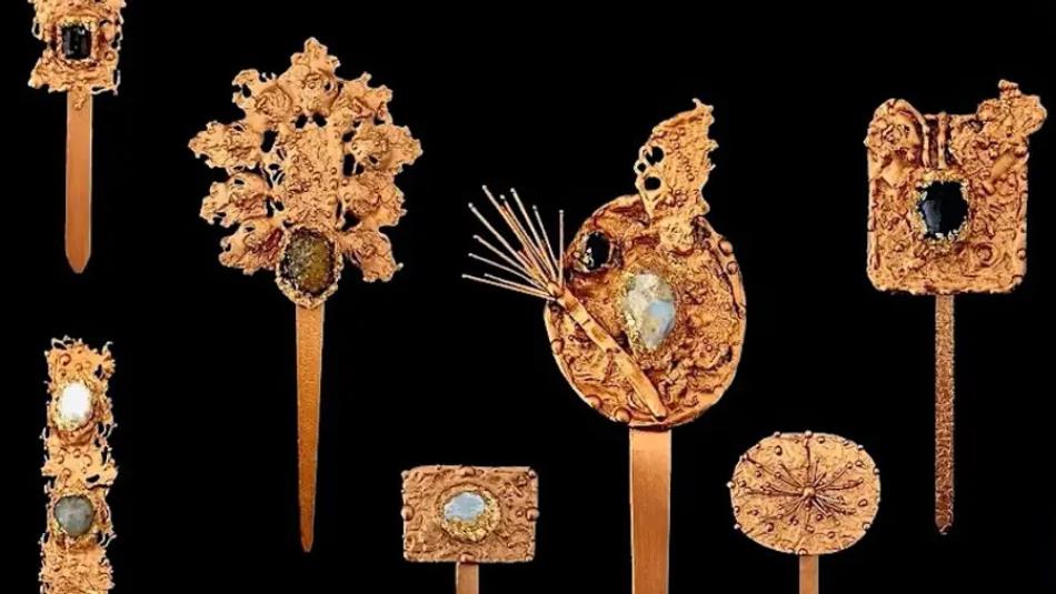 Beautiful ornate gold Korean jewellery on display with a black background