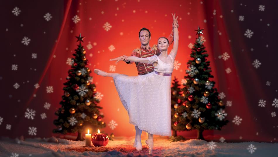 A couple performing ballet on a festive stage