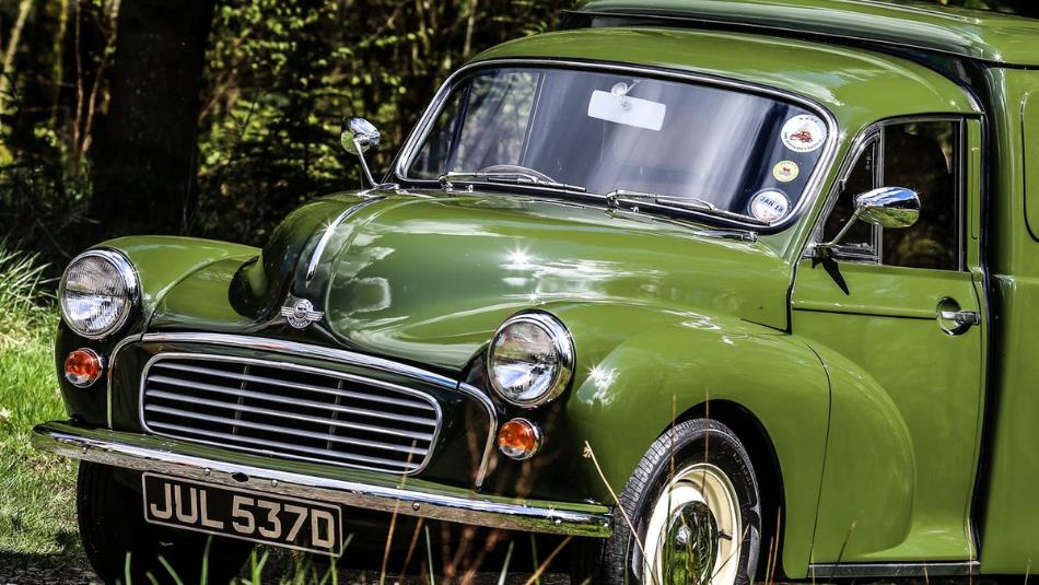Vintage green car driving up the grass