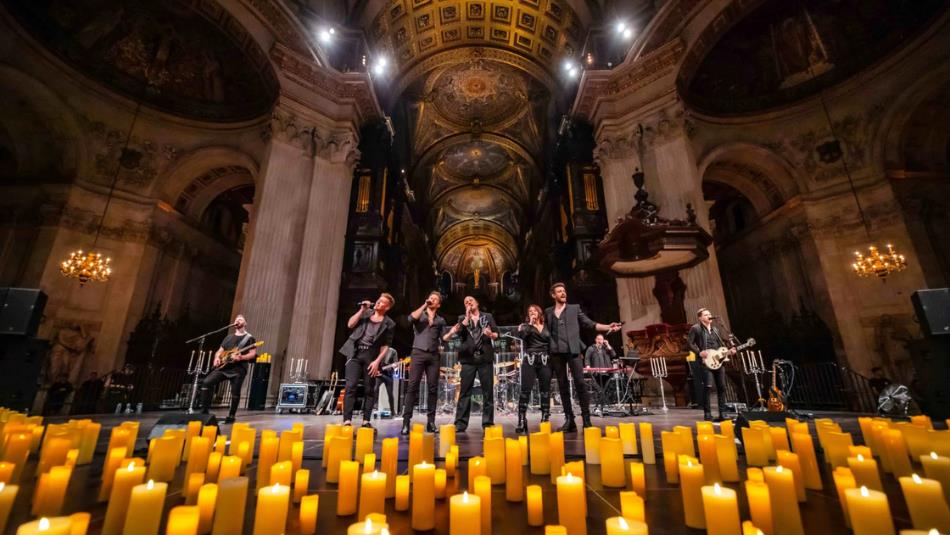 Band playing by candle light in an extravagant church