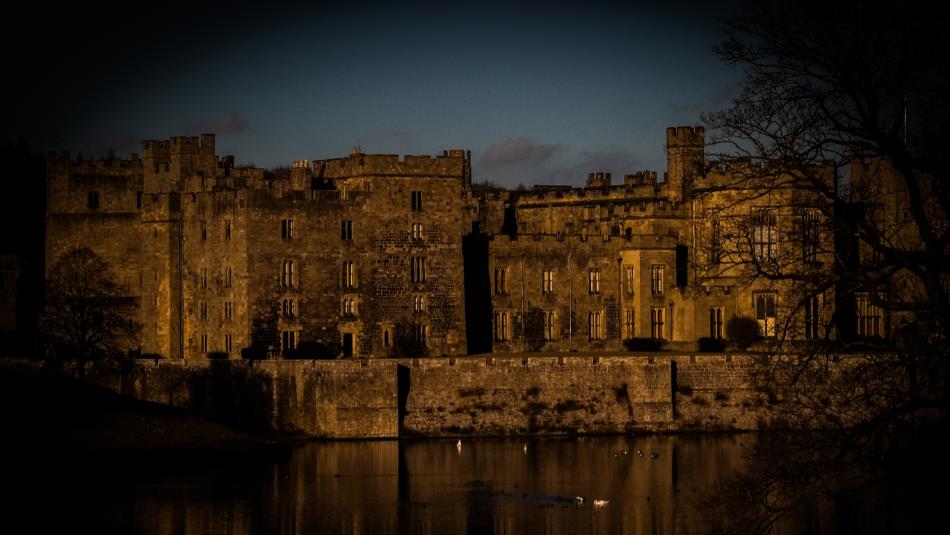 Haunted Raby: Ghost Walk Tour - Darkened picture of the castle exterior across the lake.
