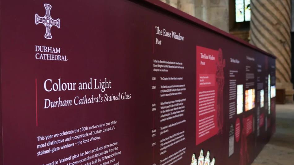 Burgundy exhibition boards of the Colour and Light exhibit in Durham Cathedral