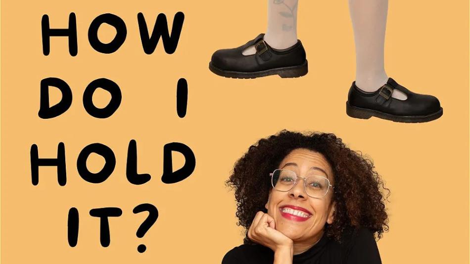 Yelloe background, with a person smiling in the bottom corner, text reading "How do I hold it?" on the left and a pair of legs wearing maryjane shoes