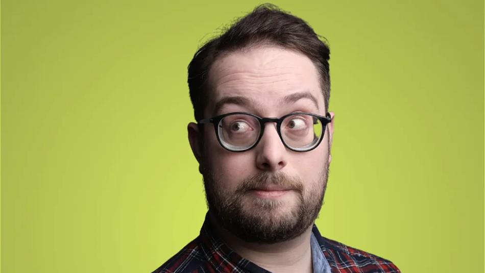 Person wearing glasses, shoulders up, looking off to the side against a lime green background.