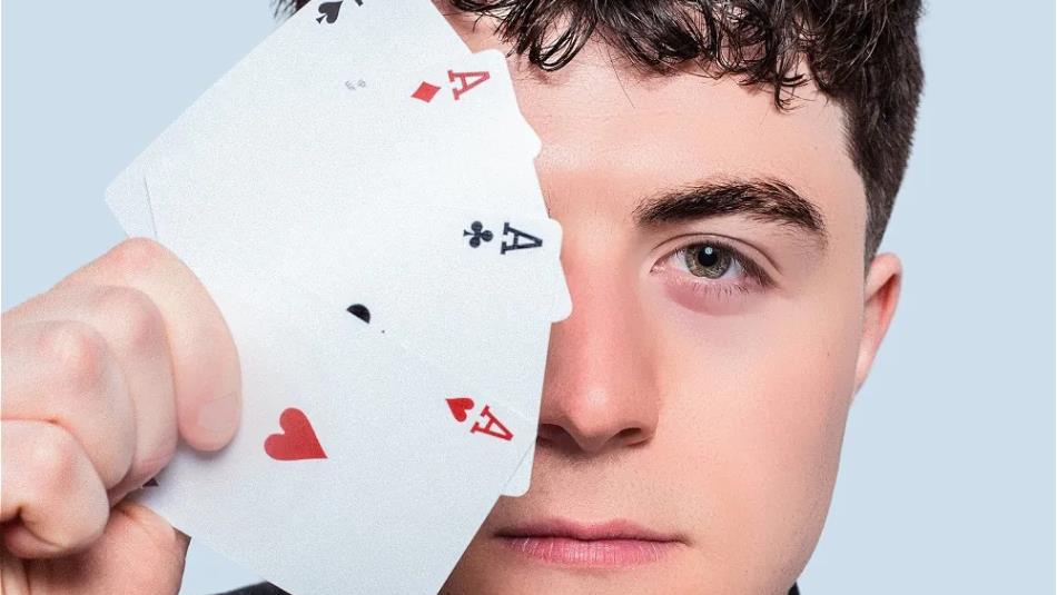 Person holding a fan of cards over their eye, against a light blue background