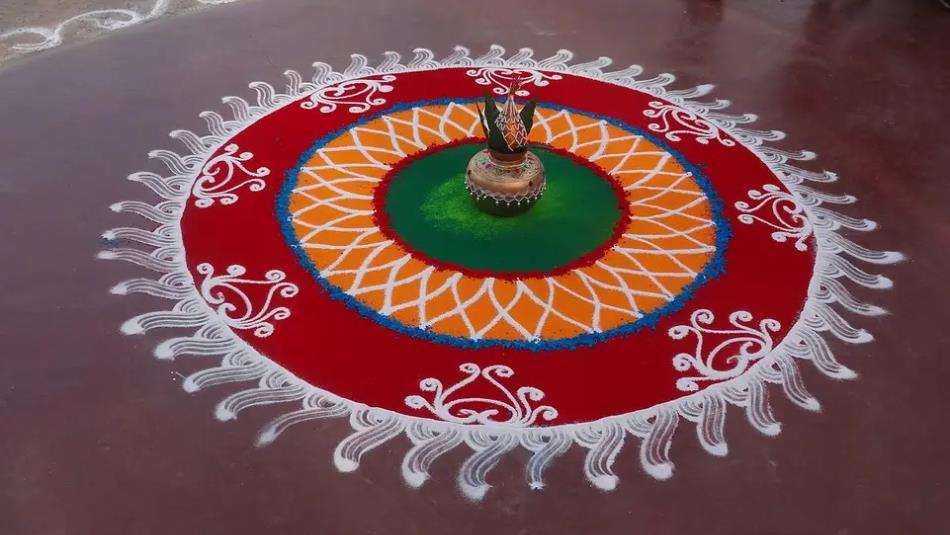 A beautiful circular rangoli, with intricate red and white details