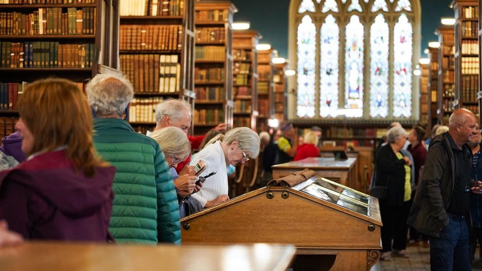 People visiting the library at Ushaw Historic House, Chapels and Gardens