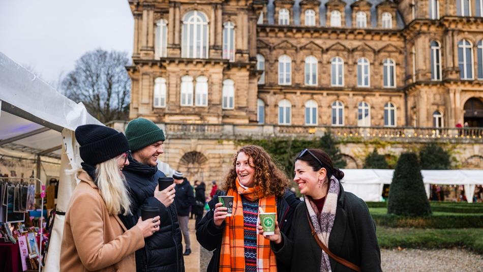 Four friends enjoying festive drinks at The Bowes Museum Winter Market. ©TheBowesMuseum