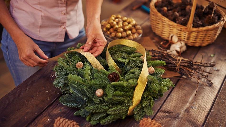 someone making a Christmas Wreath