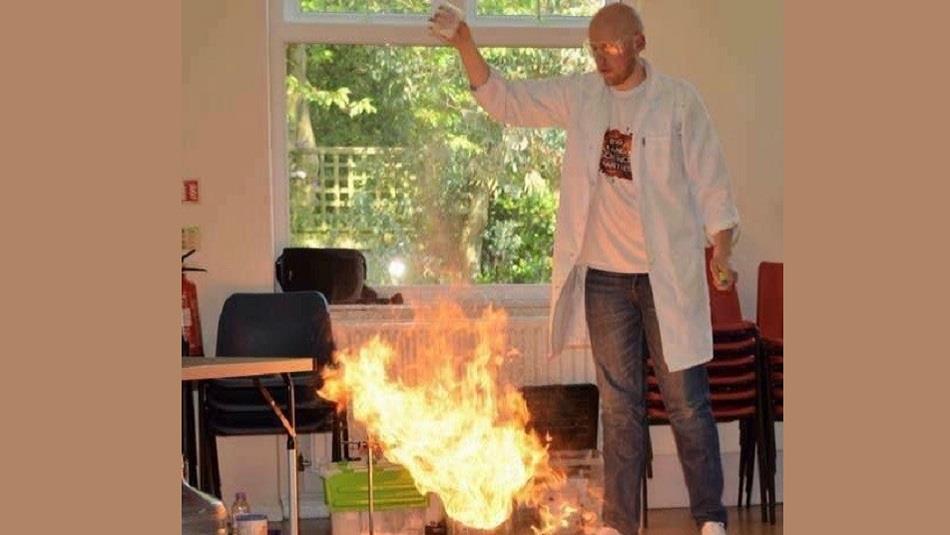 A man performing a science experiment with fire.