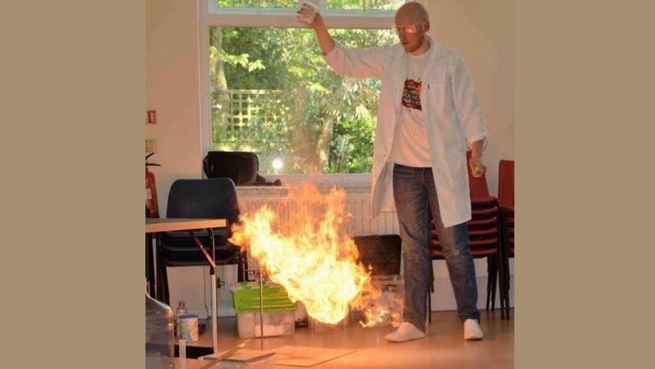 Man demonstrating a science experiment with fire
