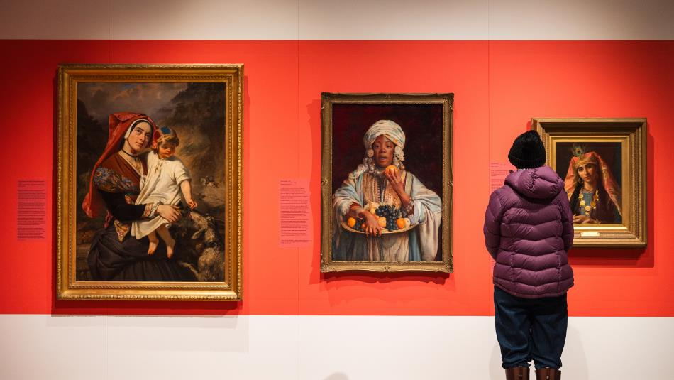 A visitor admiring portraits at The Bowes Museum from the Joséphine Bowes Trendsetters and Trailblazers exhibition