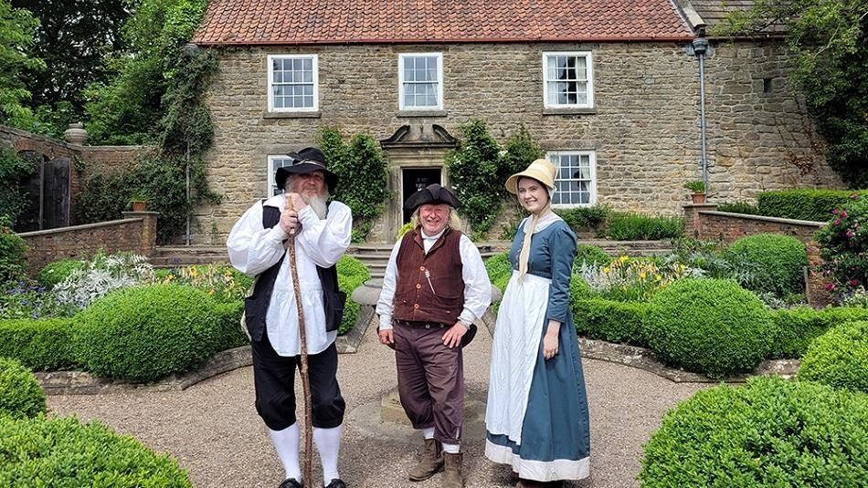 Pockerley at Beamish with three people dressed in period dress