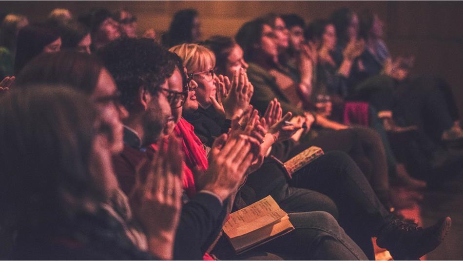 Image of a group of people at a Durham Book Festival event who are seated and clapping.