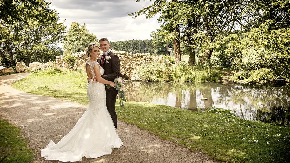 Two people in front of a lake