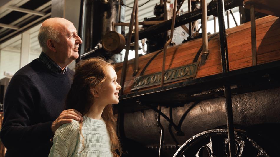 Grandad and Granddaughter looking at Locomotion