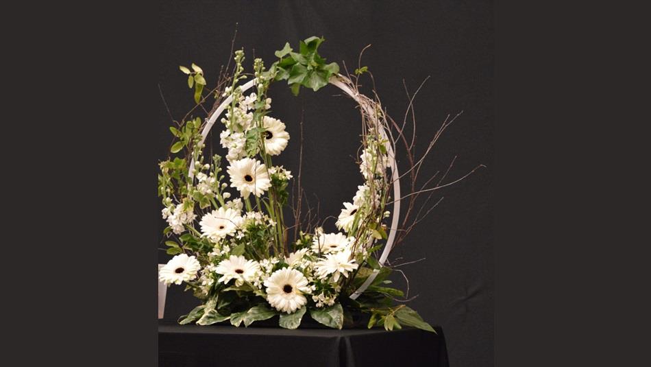 Arrangement of white flowers around a circular frame