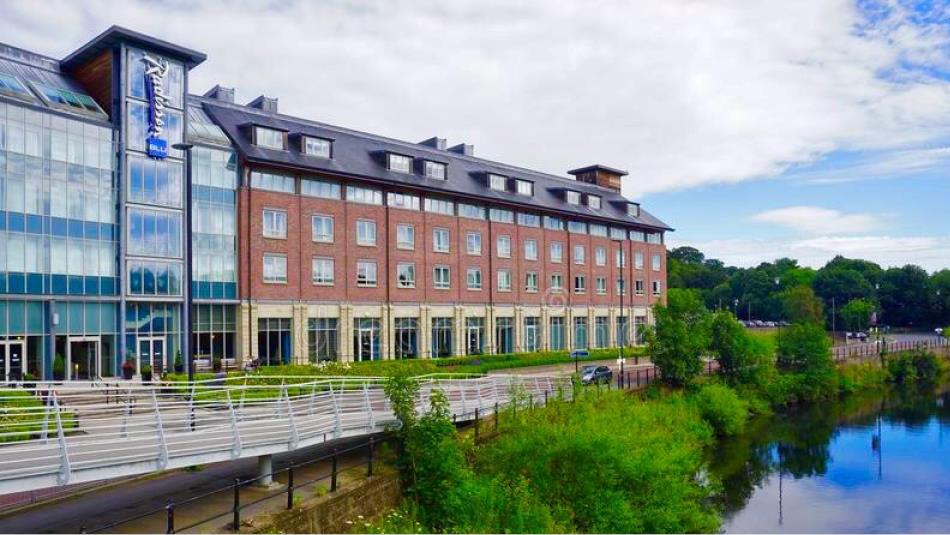 Exterior view of the Radisson Blu overlooking river.