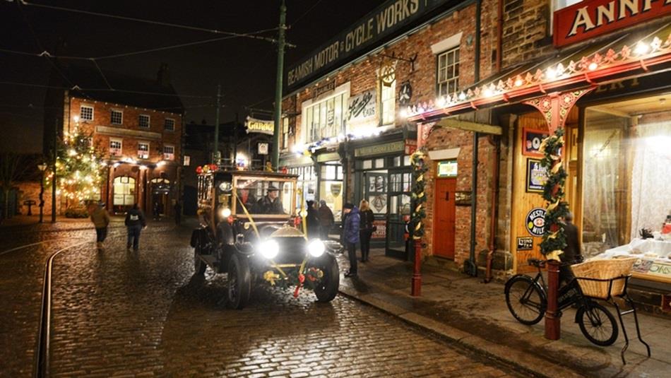 A Christmas evening at Beamish Museum with a vintage car and Christmas lights