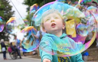 A child playing with bubbles at Hopetown Darlington.