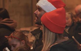 A family attending Carols for All at Durham Cathedral.