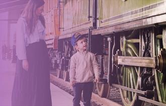 Young boy and mum looking at a train at Locomotion in Shildon.