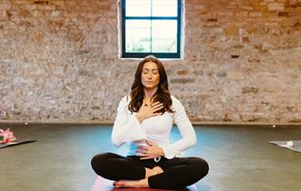 Lucy Pringle sitting in a meditative pose. Credit: Chris Parkinson