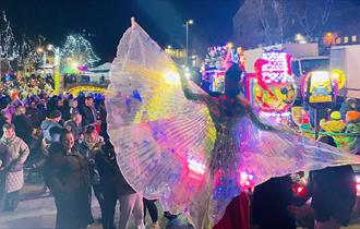 Crowds enjoying fairground rides and performances in Sacriston.