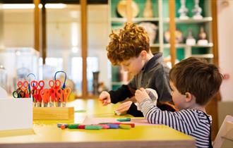 Two children participating in Arts and Crafts activities at The Bowes Museum