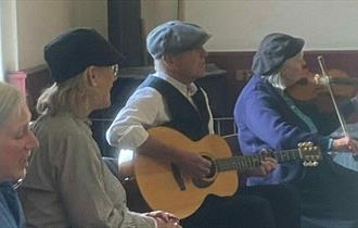 The Cloth Cappers performing in The Band Hall in the Pit Village