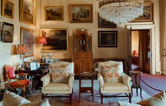 Opulent room at Raby Castle with a chandelier and paintings