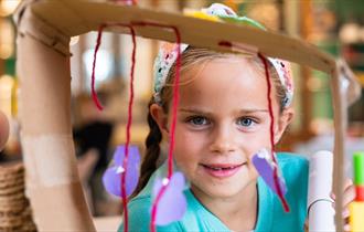 Little girl making a sculpture from wool.