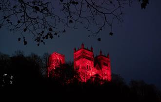Durham Cathedral at night lit up in red