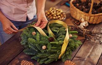 someone making a Christmas Wreath